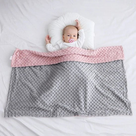 Couverture bébé étalé sur un bébé allongé